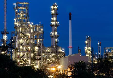 Oil and gas refinery plant firm industry zone at night.