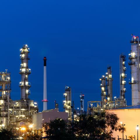 Oil and gas refinery plant firm industry zone at night.