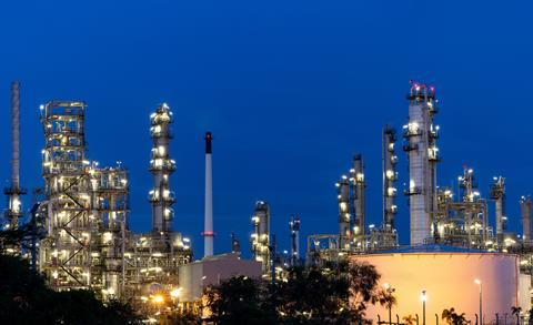 Oil and gas refinery plant firm industry zone at night.